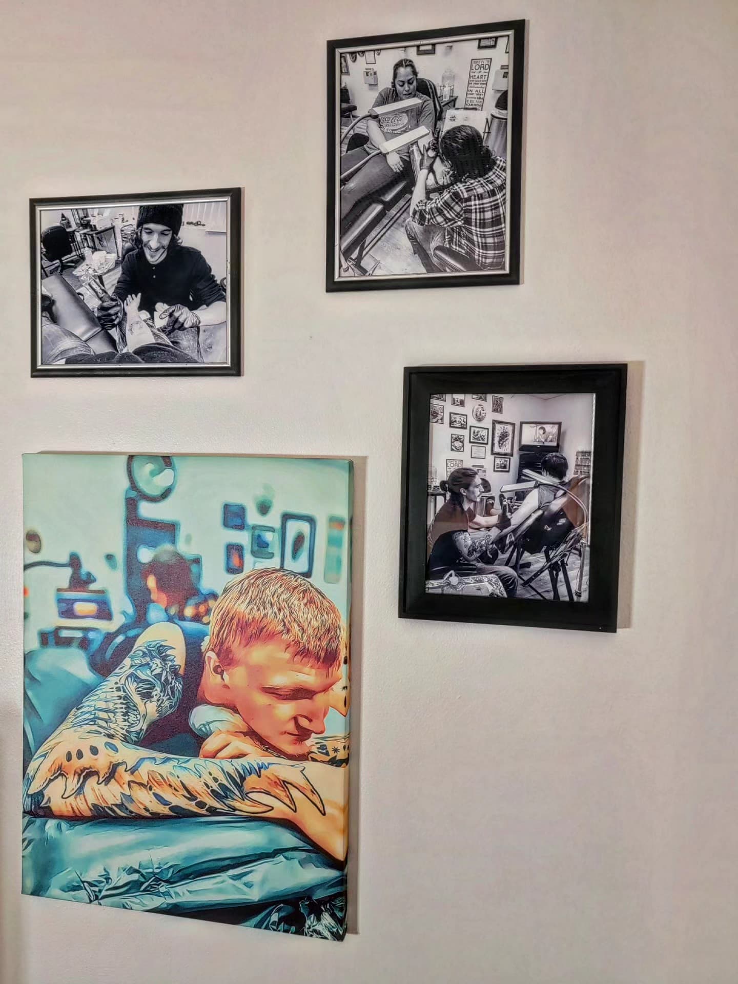 Wall display of four framed black-and-white photographs