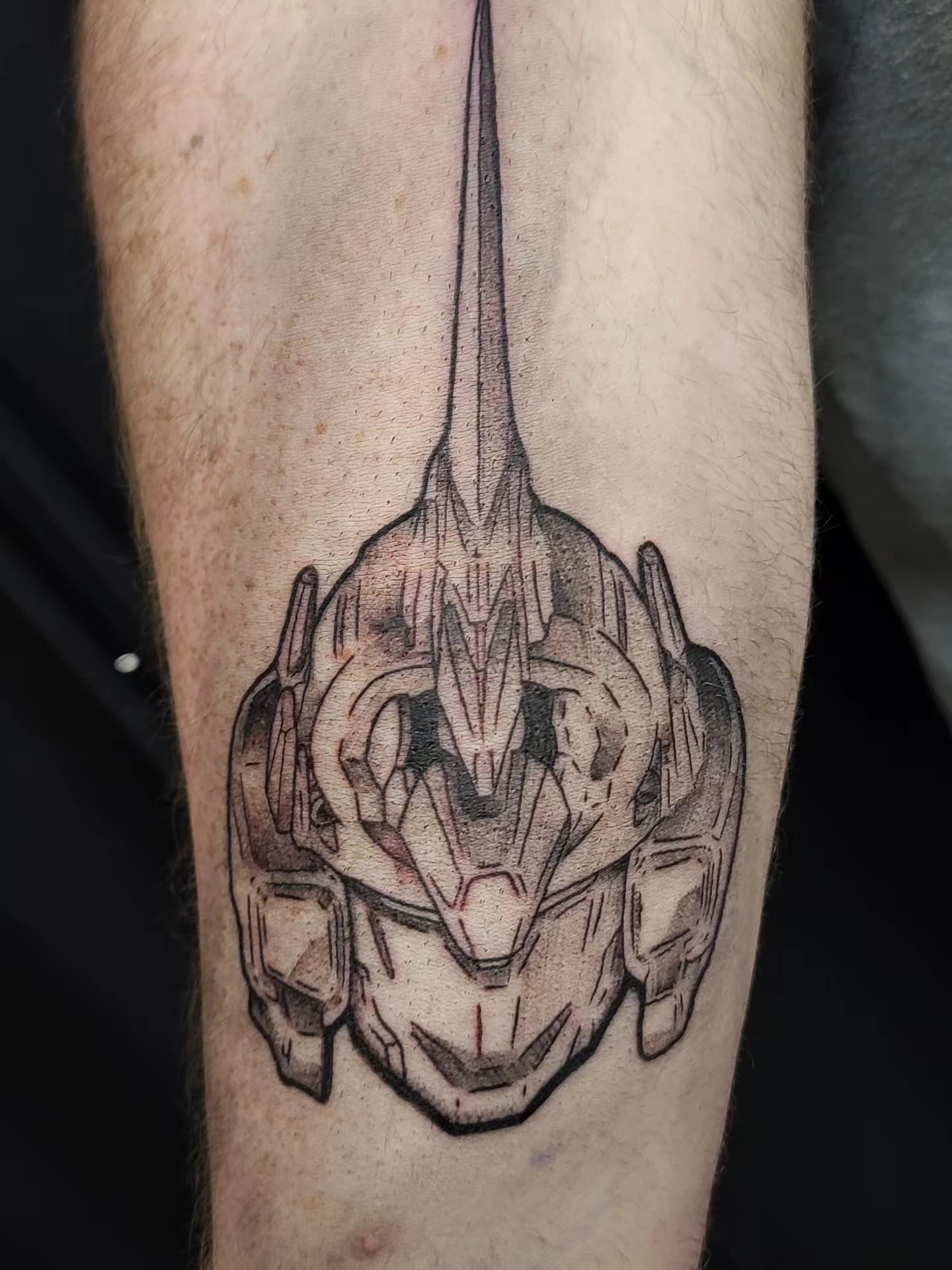Ornate geometric helmet tattoo on leg