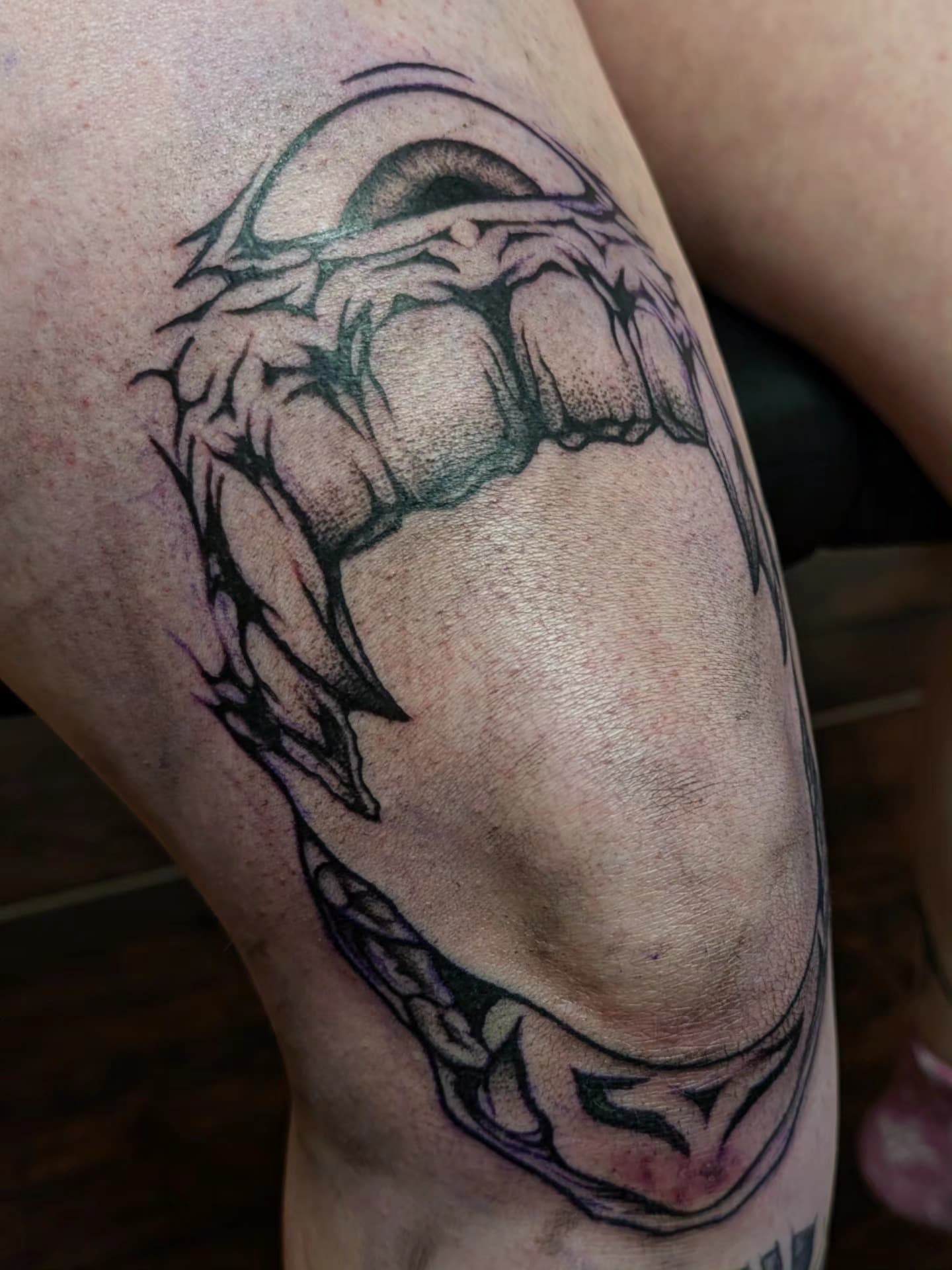 Anatomical heart tattoo in black and purple ink