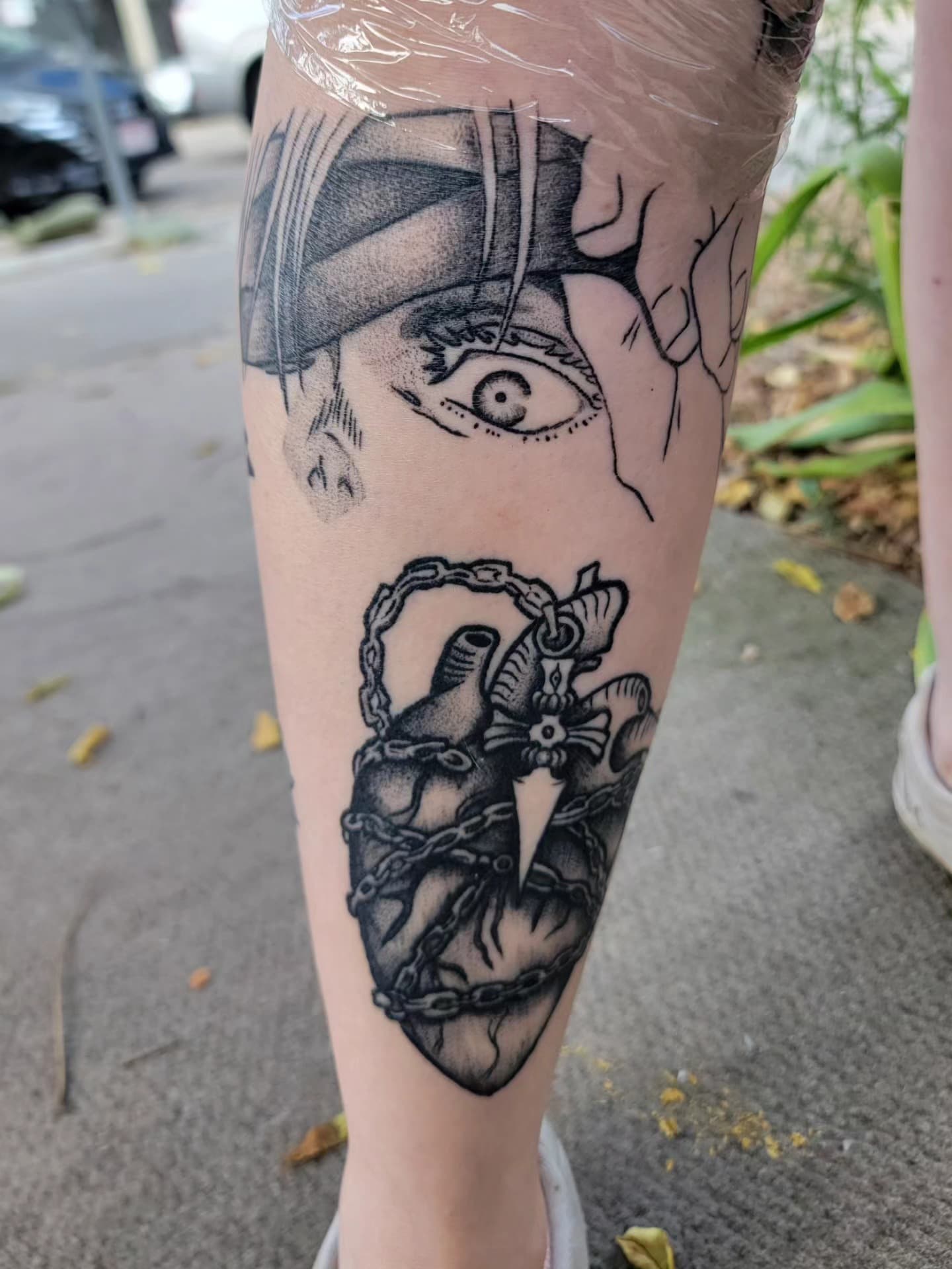 Line-work eye and anatomical heart tattoo