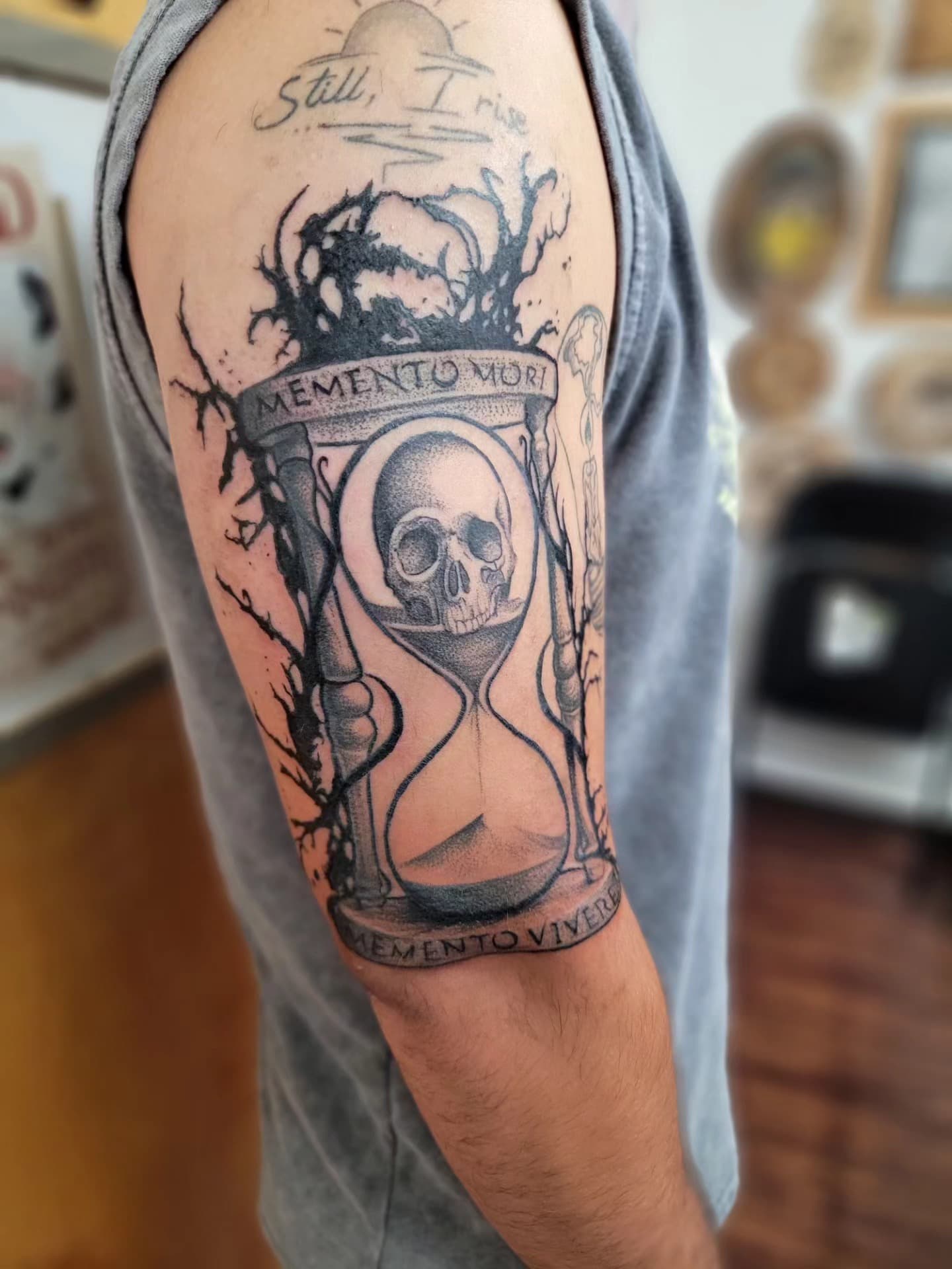 Close-up hourglass-and-skull tattoo