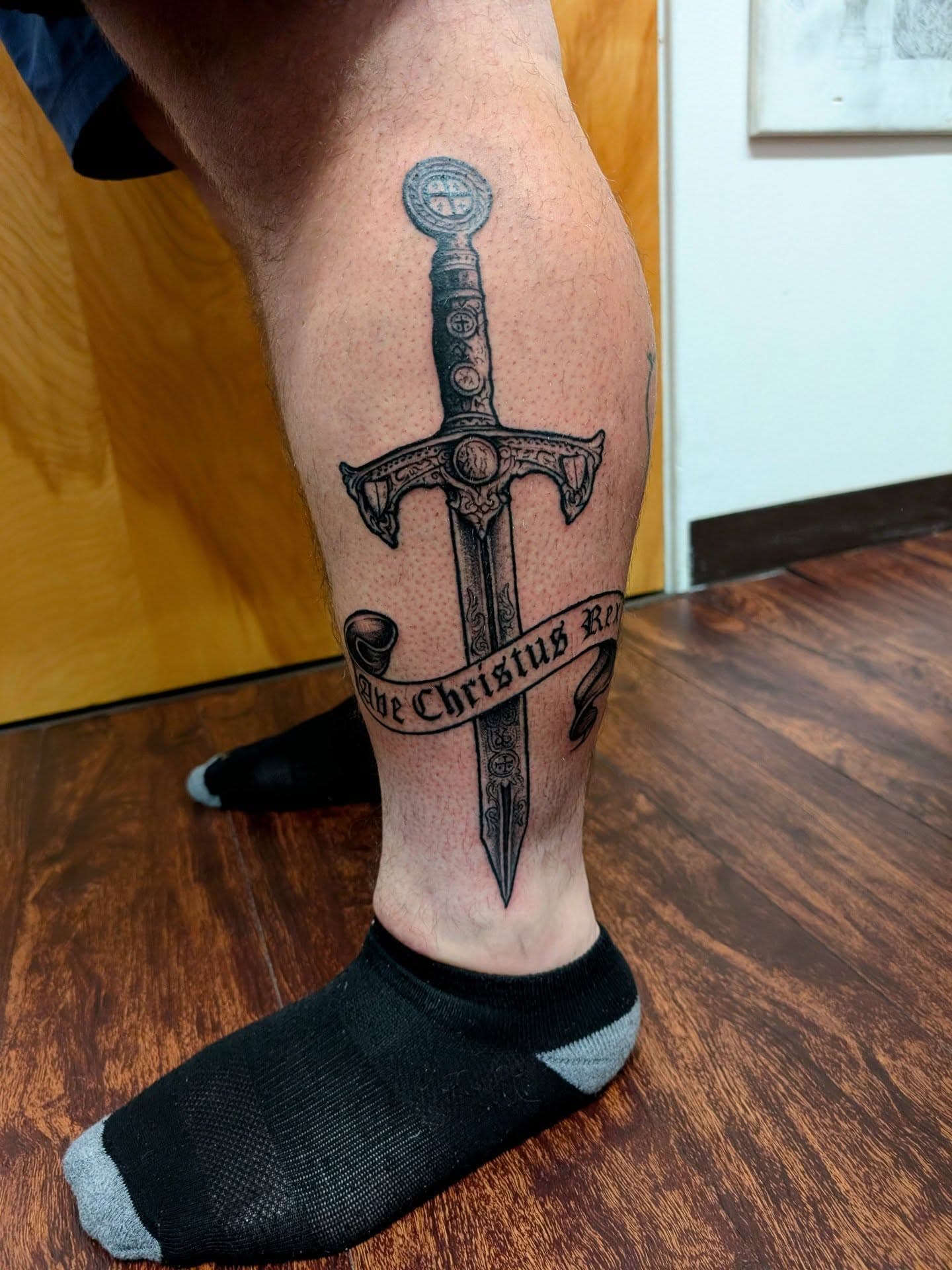 Cross sword tattoo with surrounding text