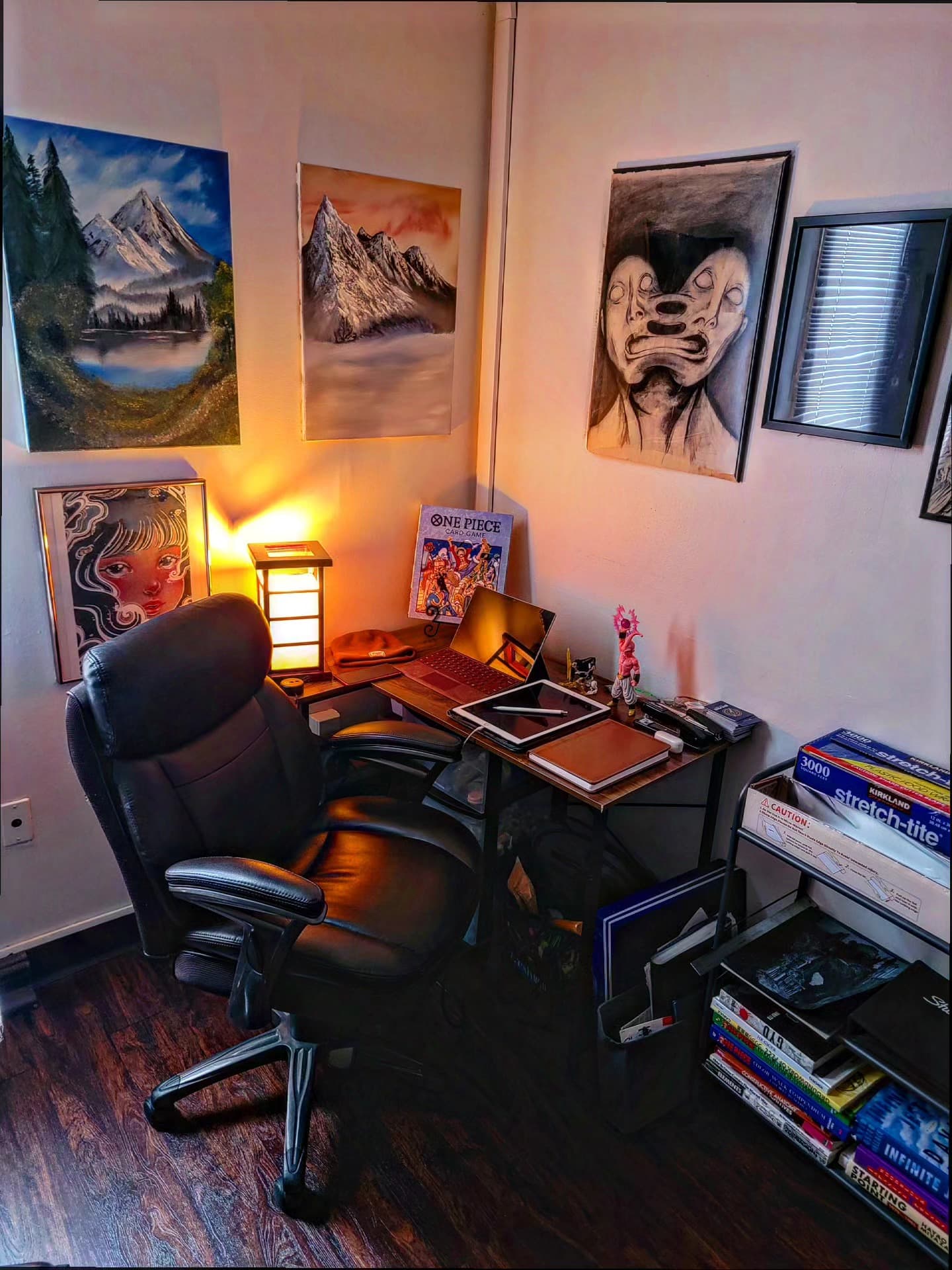 Workspace setup with desk, chair, and wall art