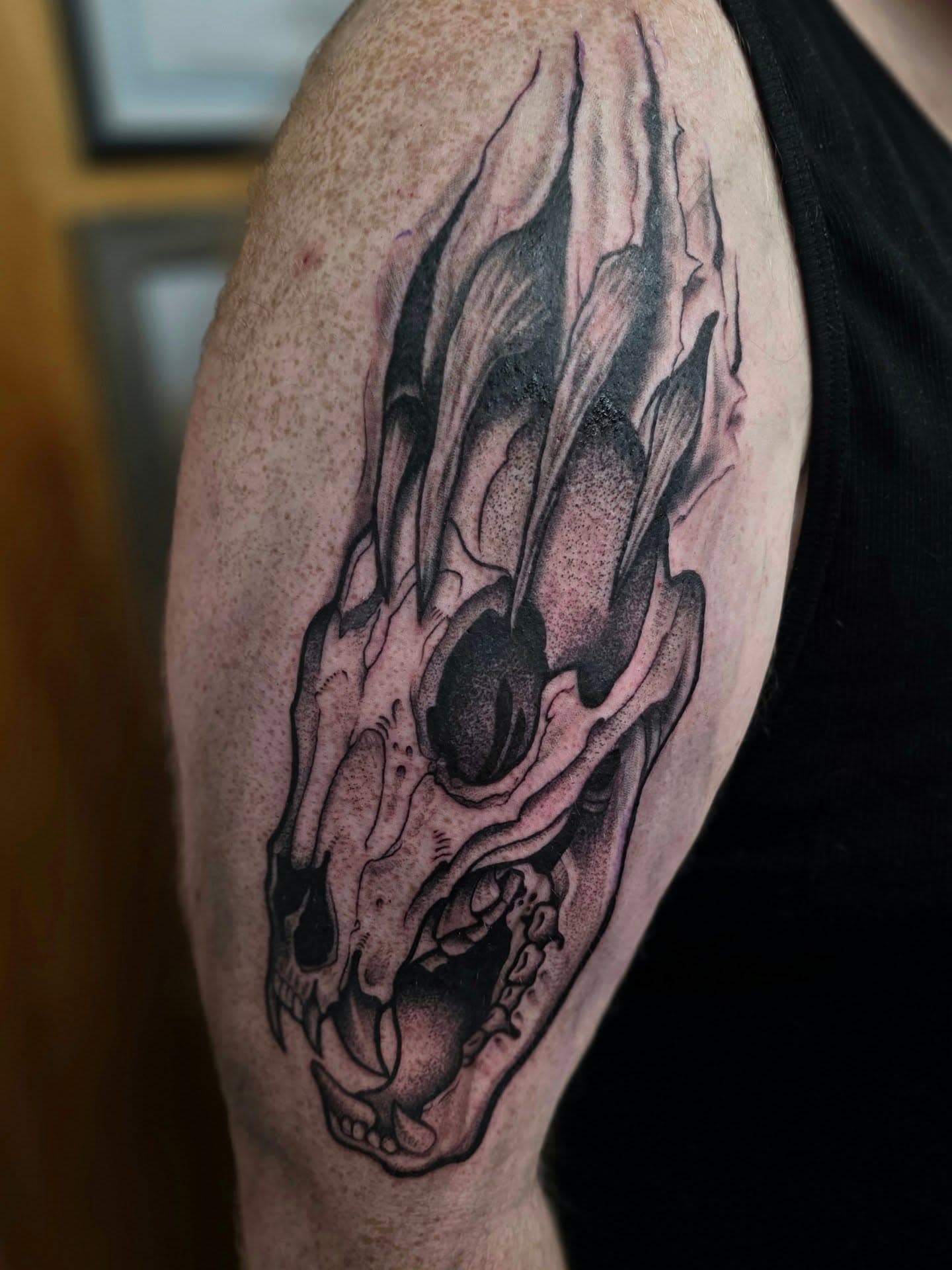 Flaming skull tattoo with claw marks