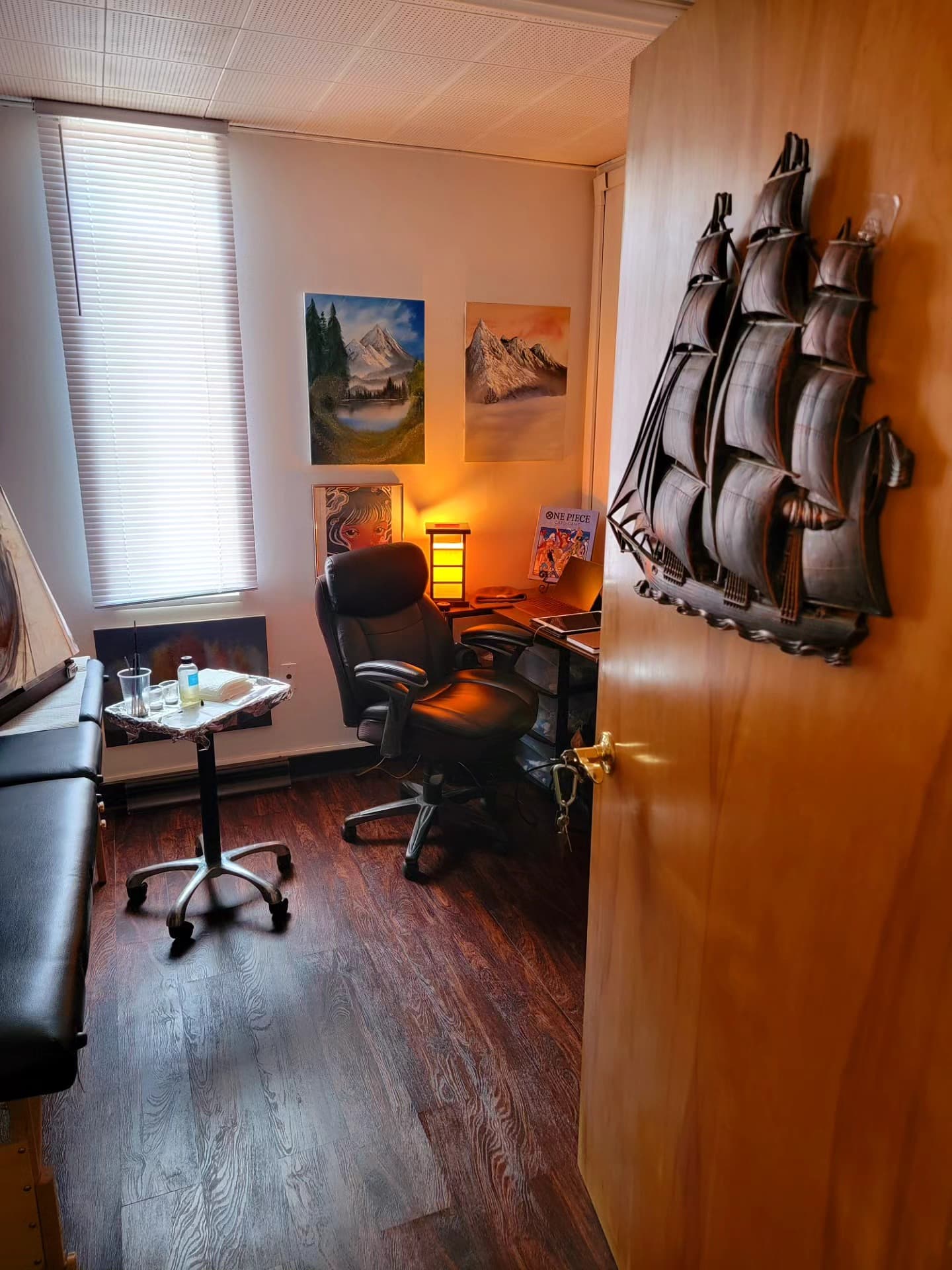 Wide view of the studio with ship model and warm lighting